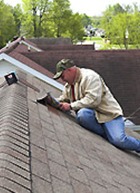 Roofing contractor on roof